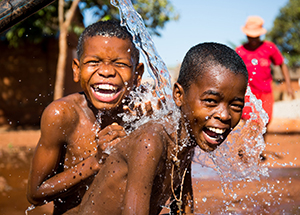 Children happily bathing in clean water