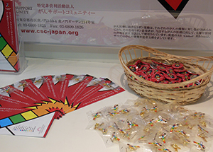 A cancer prevention leaflet and a rainbow ribbon badge